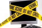 A desktop computer with a monitor wrapped in “crime scene” tape.