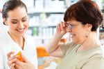 woman pharmacist showing prescription medication to customer